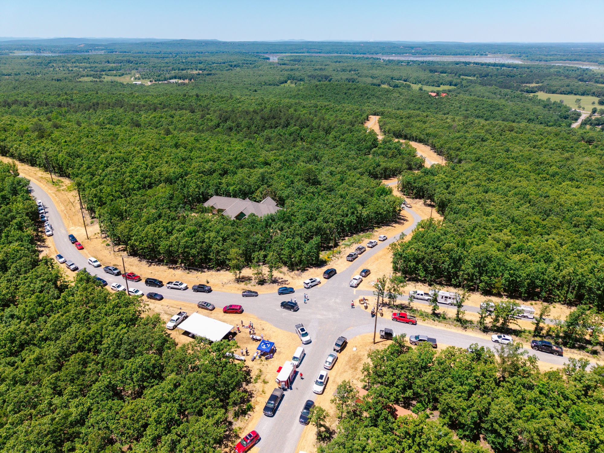 Pinnacle Mountain visible across miles of forest from the hilltop road at 7 Lakes Ranch Estates